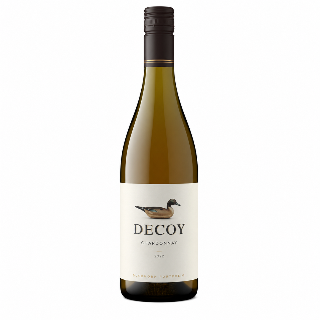 A bottle of Decoy Chardonnay white wine, featuring a cream-colored label with a duck illustration and a dark green glass bottle, set against a plain white background.