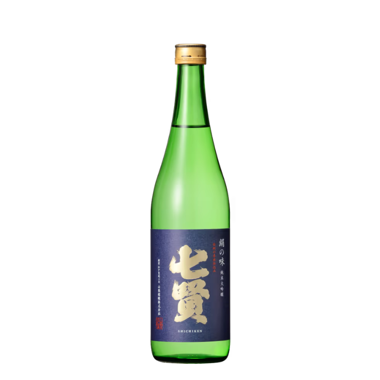 Green bottle of sake with dark purple label and gold Japanese lettering